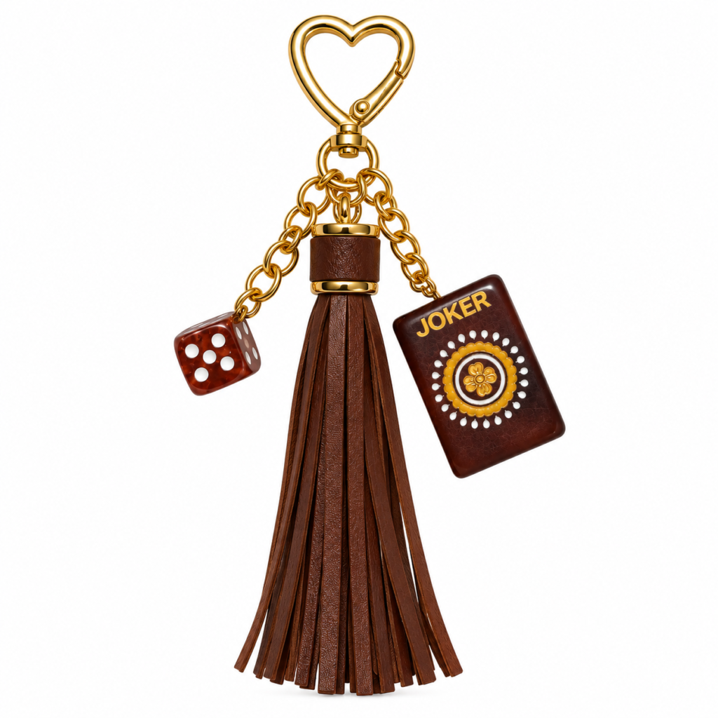 Brown tassel mahjong keychain with a joker tile, dice charm, and gold heart clasp